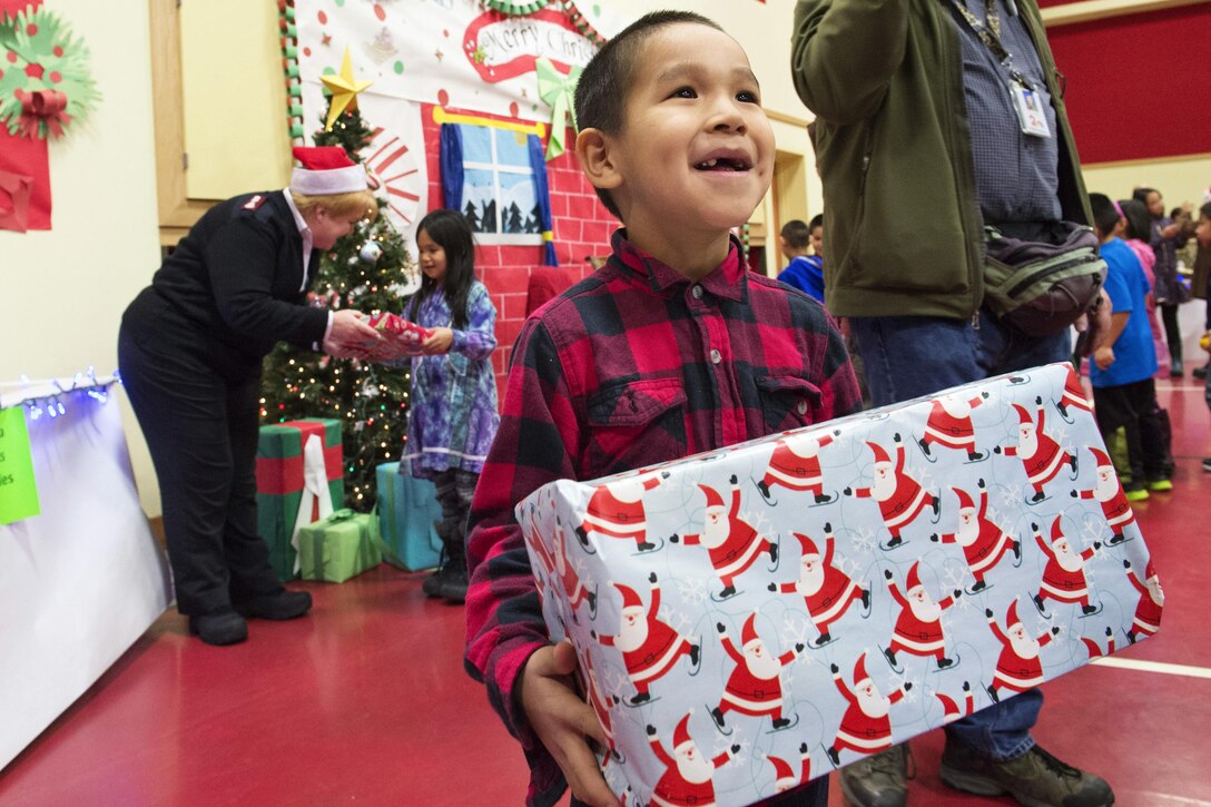 Elementary school students receive gifts during Operation Santa Claus at St. Mary's Alaska, Dec. 5, 2015. U.S. Air Force photo by Alejandro Pena