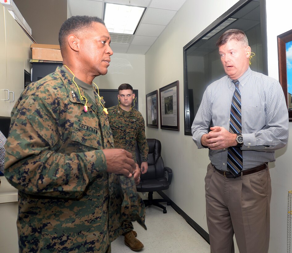 Fred Broome, director, Installation and Environmental Division, Marine Corps Logistics Base Albany, gives information to Maj. Gen. Craig C. Crenshaw, commanding general, Marine Corps Logistics Command, about the landfill gas generator during a tour, Dec. 16.