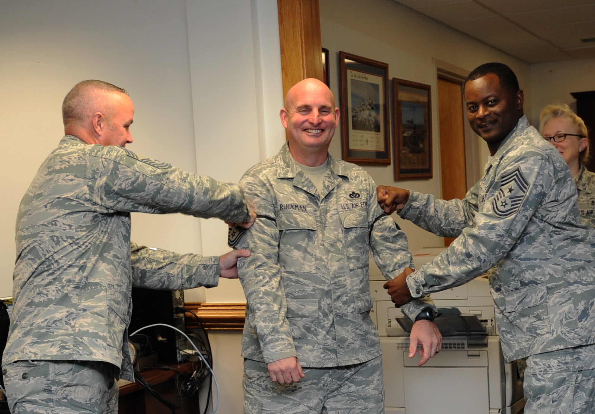 Senior Master Sgt. Jeffrey Ruckman, 366th Training Squadron Detachment 6 supervisor, Gulfport, Miss., is congratulated with a ceremonial promotion pinning on by Chief Master Sgts. Michael Lemond, 2nd Air Force military training leader, and Harry Hutchinson, 81st Training Wing command chief, at the 2nd AF headquarters building Dec. 17, 2015, Keesler Air Force Base, Miss. Keesler had six senior master sergeants selected for promotion to the rank of chief master sergeants. (U.S. Air Force photo by Kemberly Groue)