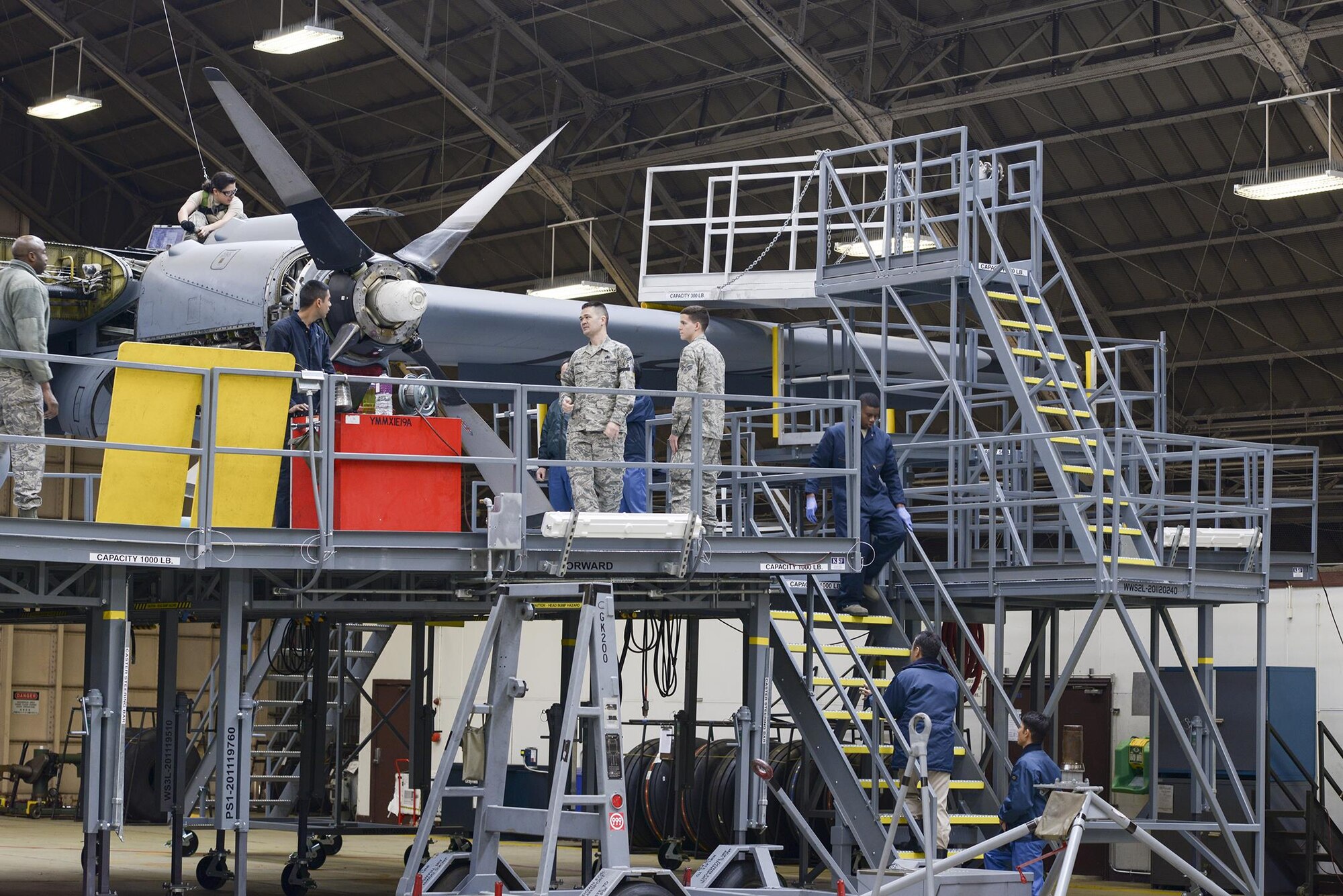 Japan Maritime Self-Defense Force members watch an isochronal inspection conducted at Yokota Air Base, Japan, Dec. 11, 2015. The JMSDF members were engine and electrician maintainers with the 4 Maintenance Squadron from Atsugi Air Base, Japan. (U.S. Air Force photo by Staff Sgt. Cody H. Ramirez/Released)