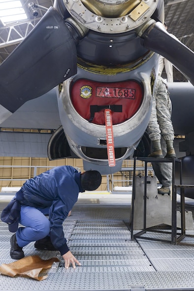 Japan Maritime Self-Defense Force Petty Officer 2nd Class Takeshi Murai, 4 Maintenance Squadron, inspects a C-130 Hercules engine during a facility tour at Yokota Air Base, Japan, Dec. 11, 2015. The JMSDF maintainers compared the maintenance conducted at Yokota to their own to help improve processes and efficiency. (U.S. Air Force photo by Staff Sgt. Cody H. Ramirez/Released)