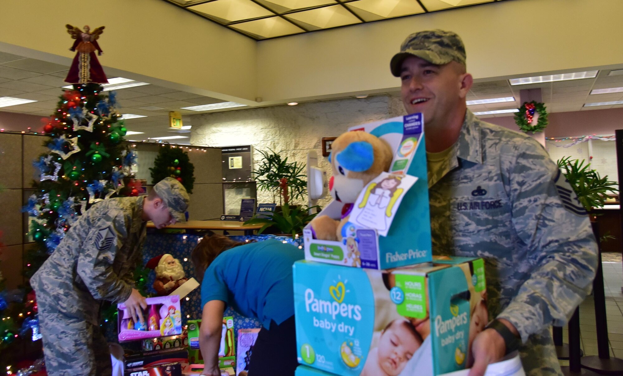 MSgt Jacob Davidson, First Sergeant, 647th Civil Engineering Squadron, carries donations to the Angel Tree program to his vehicle on Joint Base Pearl Harbor-Hickam  Dec. 17, 2015. The Angel Tree program, which provides monetary assistance and gifts to Airmen, is a seasonal charitable program ran by members of Operation Warmheart. (U.S. Air Force photo by Staff Sgt. Christopher Stoltz)