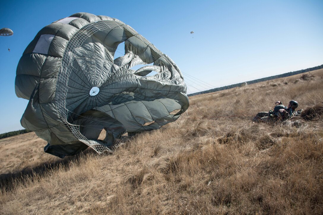 A U.S. Army paratrooper descends to the ground during Operation Toy Drop at Luzon drop zone on Fort Bragg, N.C., Dec. 8, 2015. U.S. Army photo by Pfc. Darion Gibson