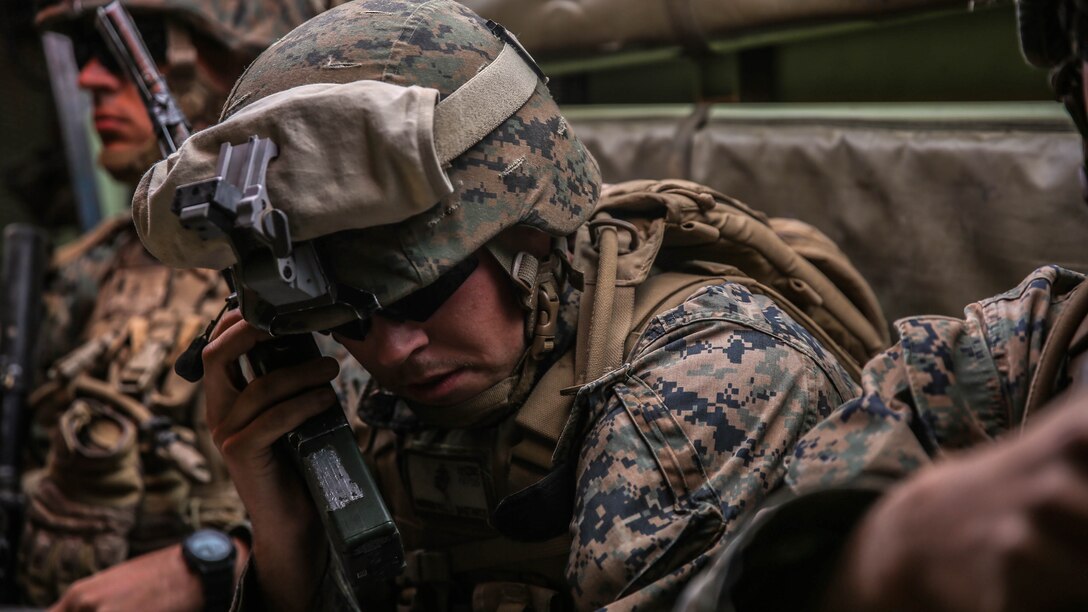 Corporal William Hastings, an intelligence analyst with Company E, 2nd Battalion, 4th Marine Regiment, 1st Marine Division, talks over the radio before deploying the Raven unmanned aerial system aboard Marine Corps Air Ground Combat Center, California, Dec. 10, 2015. The Marines employed the Raven UAS as part of Steel Knight to gain a better understanding of it and develop a higher proficiency as the ground combat element of the I Marine Expeditionary Force. 