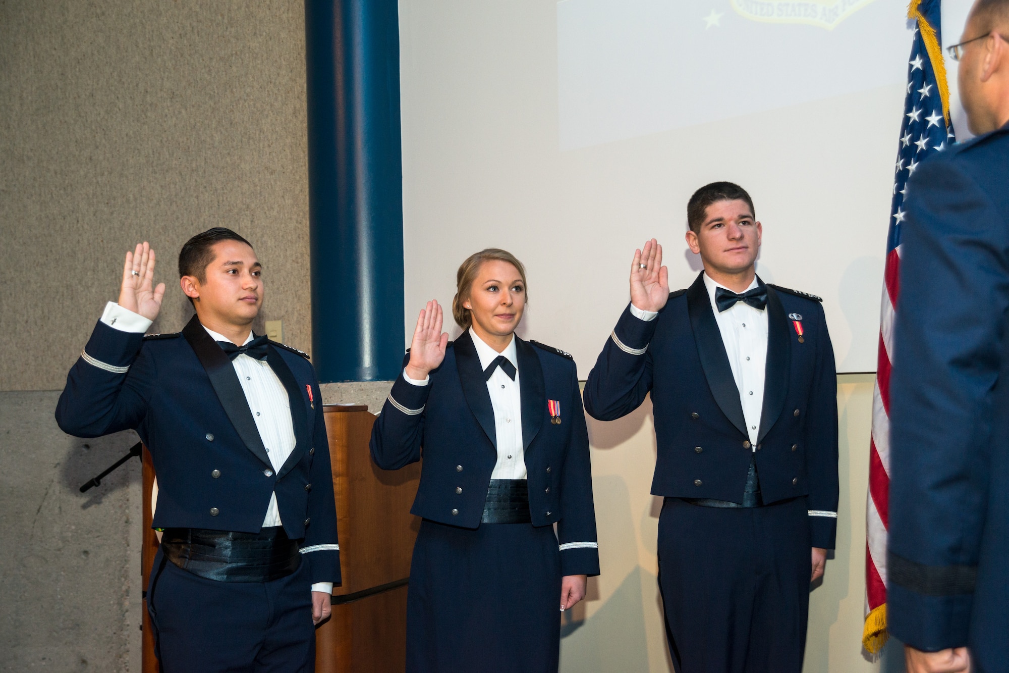 Brig. Gen. Stephen Williams, U.S. Air Force Academy commandant of cadets, administers the oath to 2nd Lts. Mark Suges, Lindsay Ebel, and Joshua Burdge Dec. 16 at the Air Force Academy's fall graduation and commissioning ceremony. (U.S. Air Force photo by Liz Copan)