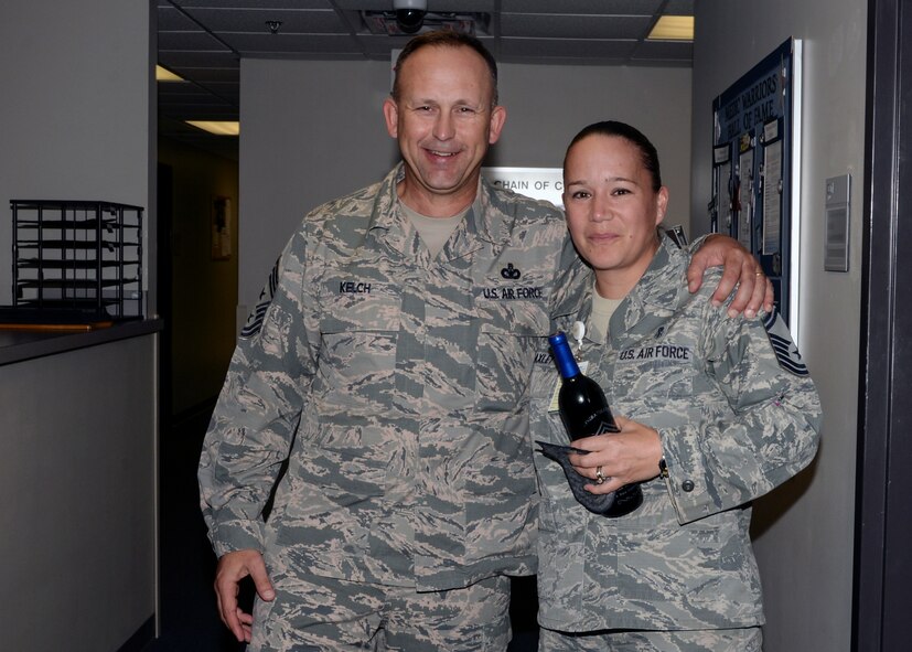 U.S. Air Force Chief Master Sgt. David Kelch, 23d Wing command chief, and Senior Master Sgt. Tarah Baxley, 23d Medical Operations Squadron superintendent, pose for a photo after receiving notification she was selected for chief master sergeant, Dec. 17, 2015, at Moody Air Force Base, Ga. Baxley. All chief master sergeants are expected to serve as mentors for commissioned and noncommissioned officers, as well as junior enlisted members. (U.S. Air Force photo by Airman 1st Class Janiqua P. Robinson/Released)