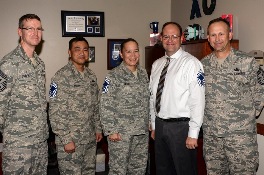 U.S. Air Force Chief Master Sgt. David Kelch, (right), 23d Wing command chief, and Chief Master Sgt. Troie Croft, (left), 93d Air Ground Operations Wing commander, pose with Moody’s newest chief master sergeant selects after they received their promotion notifications, Dec. 17, 2015, at Moody Air Force Base, Ga. Between Moody AFB, Ga., Nellis AFB, Nev., and Davis-Monthan AFB, Ariz., five senior master sergeants were selected for chief, and will soon join the upper echelon of the enlisted force. (U.S. Air Force photo by Airman 1st Class Janiqua P. Robinson/Released)