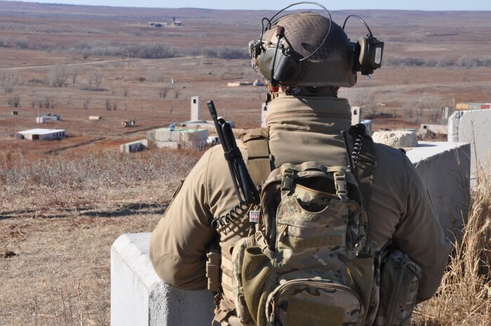 A U.S. Air Force Joint Terminal Attack Controller assigned to the 10th Air Support Operations Squadron surveys the Smoky Hill Air National Guard range during a SMOKEX exercise 10 miles south of Salina, Kan. SMOKEX, a large-force exercise, brings together joint forces and more than 10 aircraft platforms from neighboring areas, all supporting B-2 objectives for dynamic targeting.  (U.S. Air Force photo by Susan Garcia) 