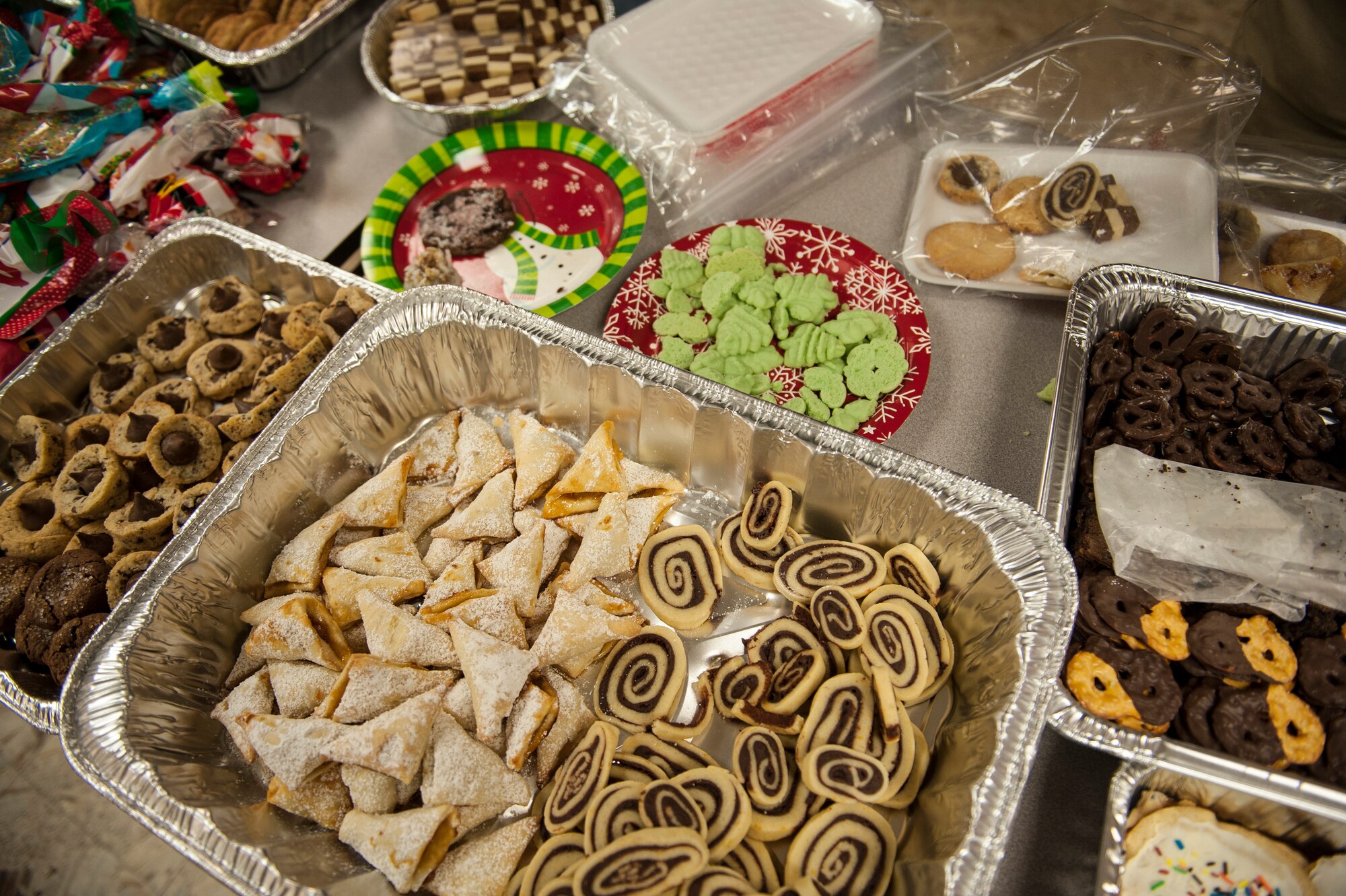 Cookies and other treats await packaging during the Airman Cookie Drive at Nellis Air Force Base, Nev., Dec. 14, 2015. More than 12,000 cookies were collected and distributed to Airmen living in the Nellis AFB dormitories. (U.S. Air Force photo by Staff Sgt. Siuta B. Ika)