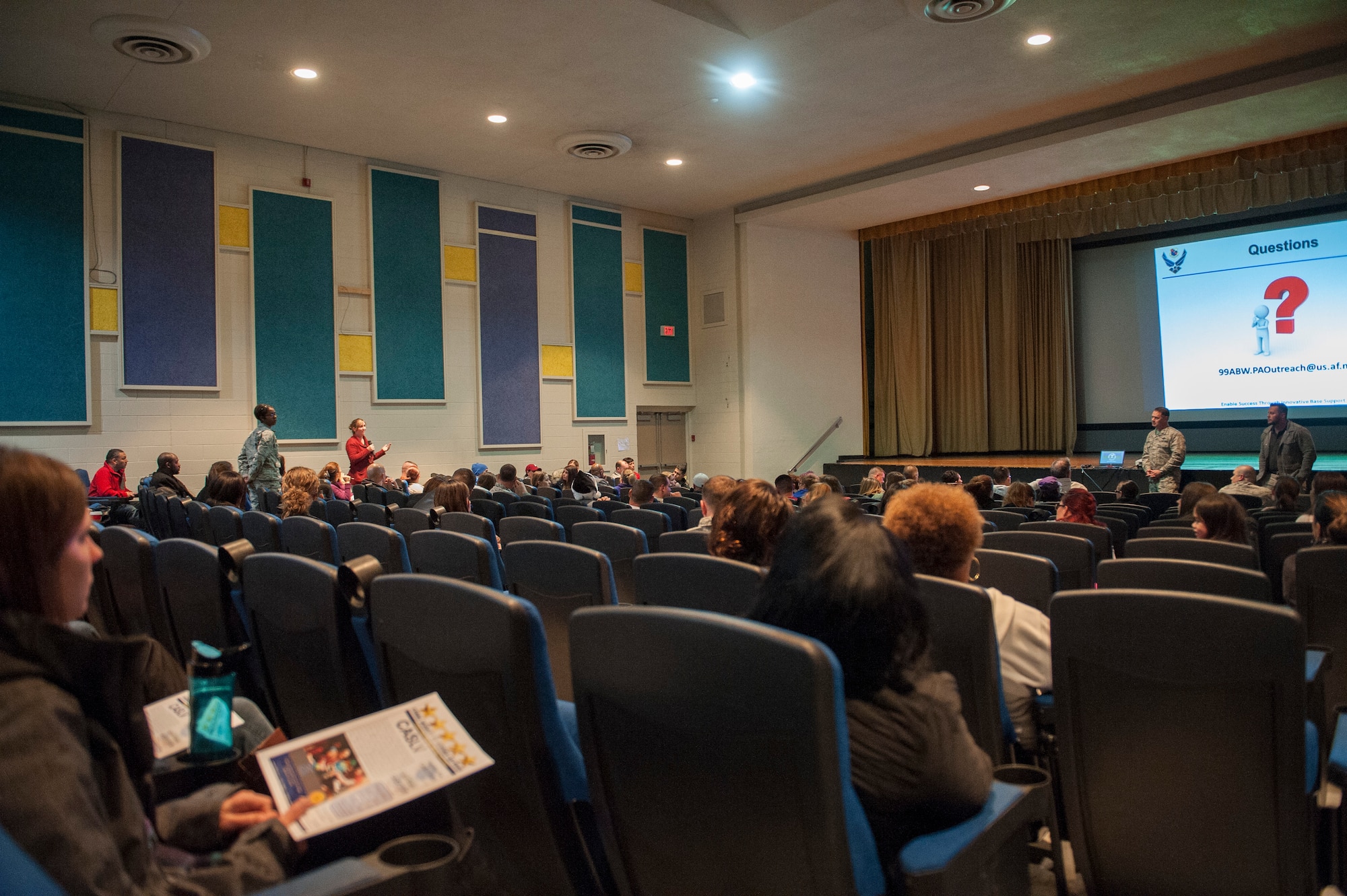 A participant in the public charter school town hall meeting poses a question to Col. Richard Boutwell, 99th Air Base Wing commander, and representatives from Coral Academy of Science Las Vegas at Nellis Air Force Base, Nev., Dec. 15, 2015. During the town hall, Boutwell and the CASLV reps discussed the base’s upcoming elementary school transition from the Clark County School District-based Lomie G. Heard Elementary School to CASLV. (U.S Air Force photo by Staff Sgt. Siuta B. Ika)