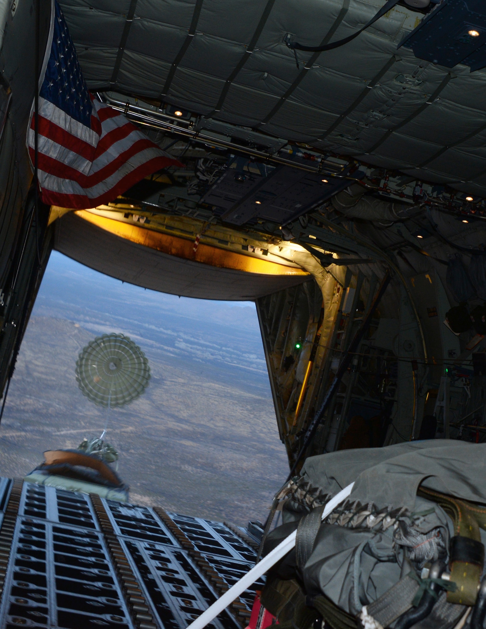 A Humvee is airdropped from a U.S. Air Force HC-130J Combat King II form the 79th Rescue Squadron during aerial delivery and recovery training with the 563rd Operations Support Squadron over Fort Huachuca, Ariz., Dec. 9, 2015. The HC-130J crew completed two drops weighing approximately 12,780 pounds. (U.S. Air Force photo by Airman 1st Class Mya M. Crosby/Released)