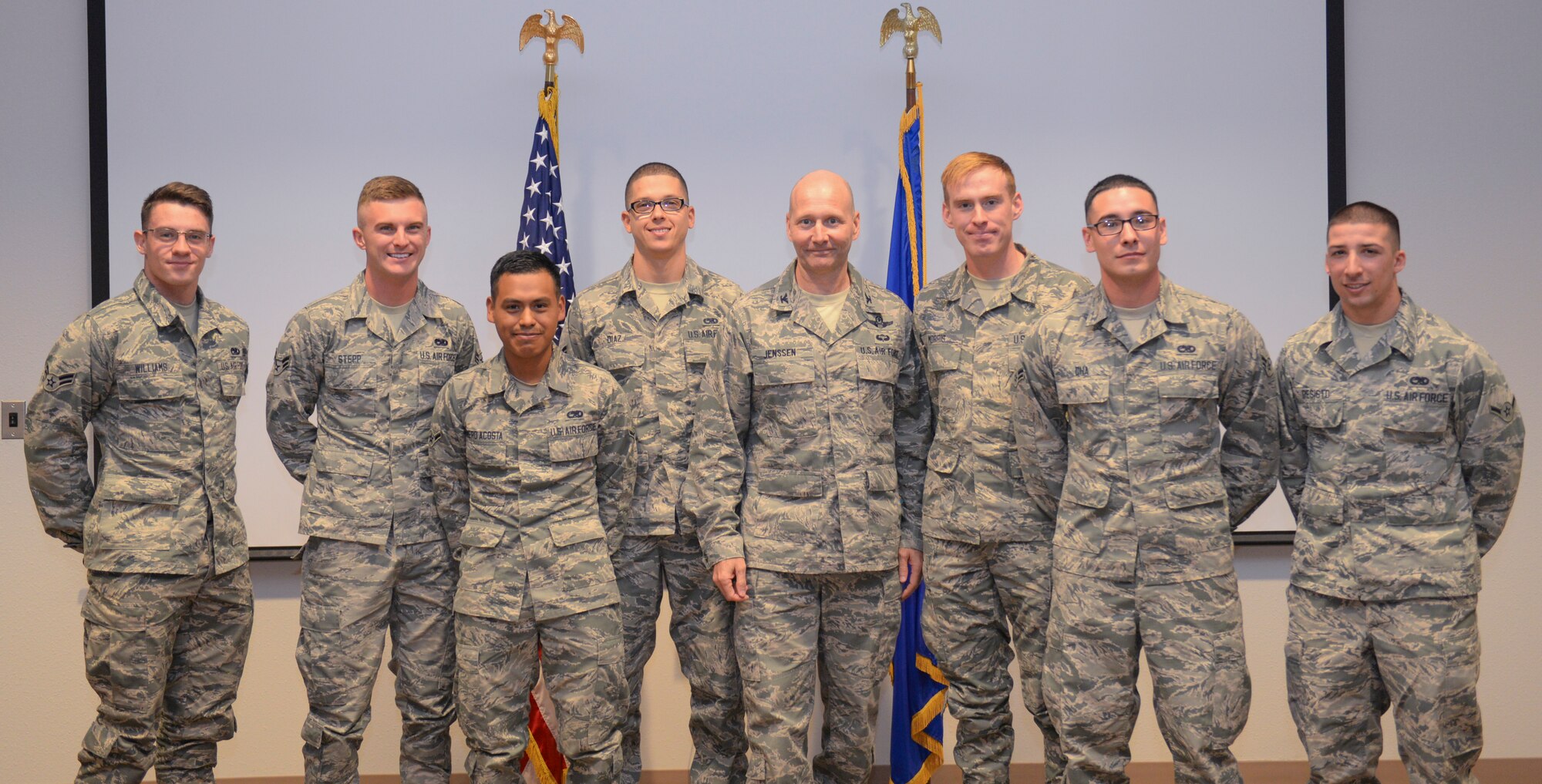 Colonel Jeffrey Jenssen, the 54th Fighter Group commander, center, poses for a picture with class 16-006 of the Sole Hands-On Training Mission Ready Airmen F-16 training course after receiving their certificates of completion at Holloman Air Force Base, New Mexico on Dec. 16. This is the first graduation of its kind to be held at Holloman. The course originally started at Luke Air Force Base, Arizona, until it was transferred here about a month ago. (U.S. Air Force photo by Staff Sgt. E’Lysia A. Wray)