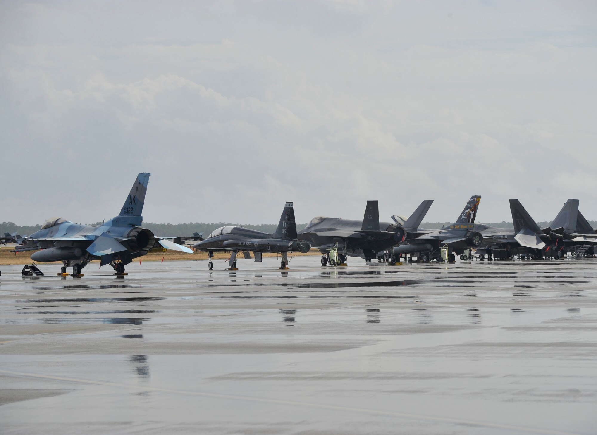 A T-38 Talon, F-35 Lightning II, F-16 Fighting Falcon and F-22 Raptor are parked at the Tyndall Air Force Base, Fla. flightline Dec. 17 during the Checkered Flag 16-1 exercise. The aircraft came from Shaw AFB, S.C.; Eglin AFB, Fla.; Barksdale AFB, La.; Tinker AFB, Okla.; and Eielson AFB, Alaska. (U.S. Air Force photo by Senior Airman Sergio A. Gamboa/Released)