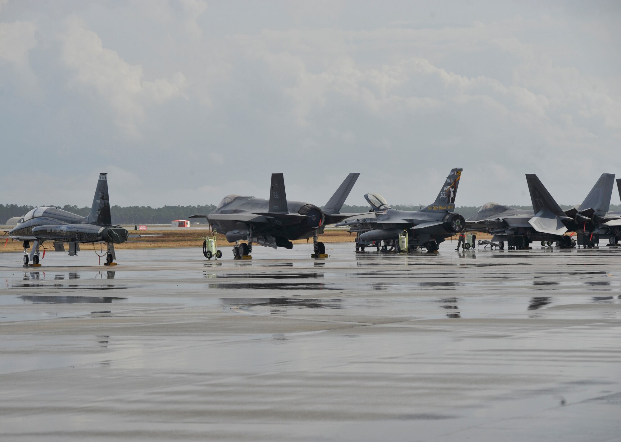 A T-38 Talon, F-35 Lightning II, F-16 Fighting Falcon and F-22 Raptor are parked at the Tyndall Air Force Base, Fla. flightline Dec. 17 during the Checkered Flag 16-1 exercise. The aircraft came from Shaw AFB, S.C.; Eglin AFB, Fla.; Barksdale AFB, La.; Tinker AFB, Okla.; and Eielson AFB, Alaska. (U.S. Air Force photo by Senior Airman Sergio A. Gamboa/Released)