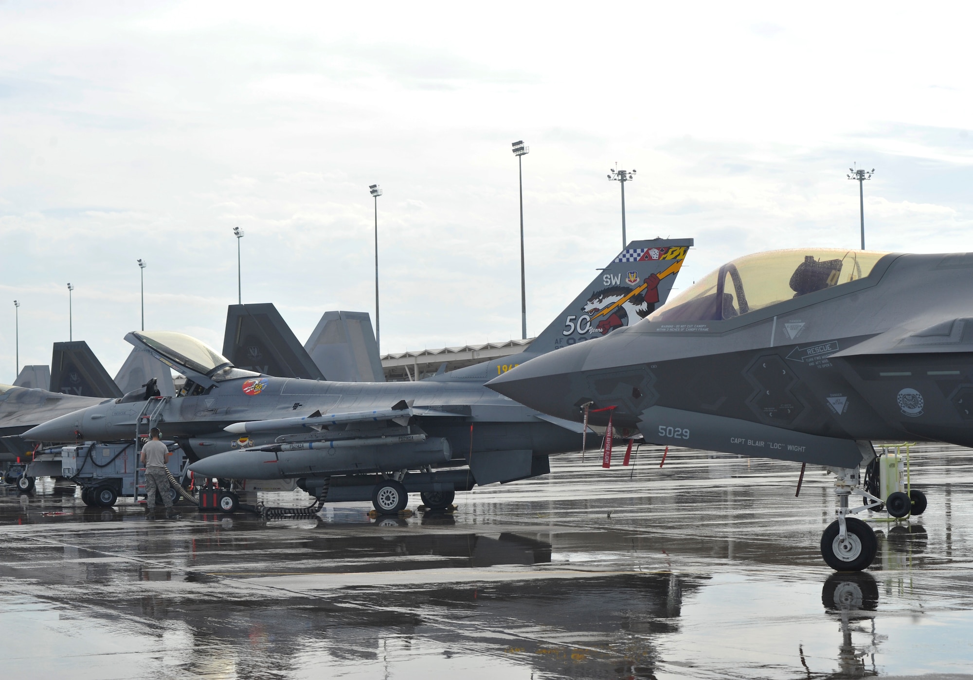A Shaw Air Force Base, S.C. F-16 Fighting Falcon is parked next to an F-35 Lightning II from Eglin AFB, Fla. Dec. 17 at the Tyndall AFB, Fla. flightline. Both Air Force bases participated in the Checkered Flag 16-1exercise, a large-force exercise that simulates employment of a large number of aircraft from a simulated deployed environment. (U.S. Air Force photo by Senior Airman Sergio A. Gamboa/Released)