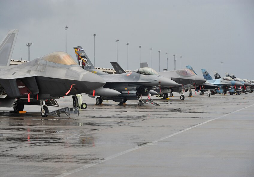 An F-22 Raptor and a T-38 Talon from Tyndall Air Force Base, Fla.; F-16 Fighting Falcons from Shaw AFB, S.C. and Eielson AFB, Alaska; F-35 Lightning II from Eglin AFB, Fla. sit on the Tyndall flightline Dec. 17 during the Checkered Flag 16-1 exercise. Checkered Flag 16-1 is a large-force exercise that simulates employment of a large number of aircraft from a simulated deployed environment.  (U.S. Air Force photo by Senior Airman Sergio A. Gamboa/Released)