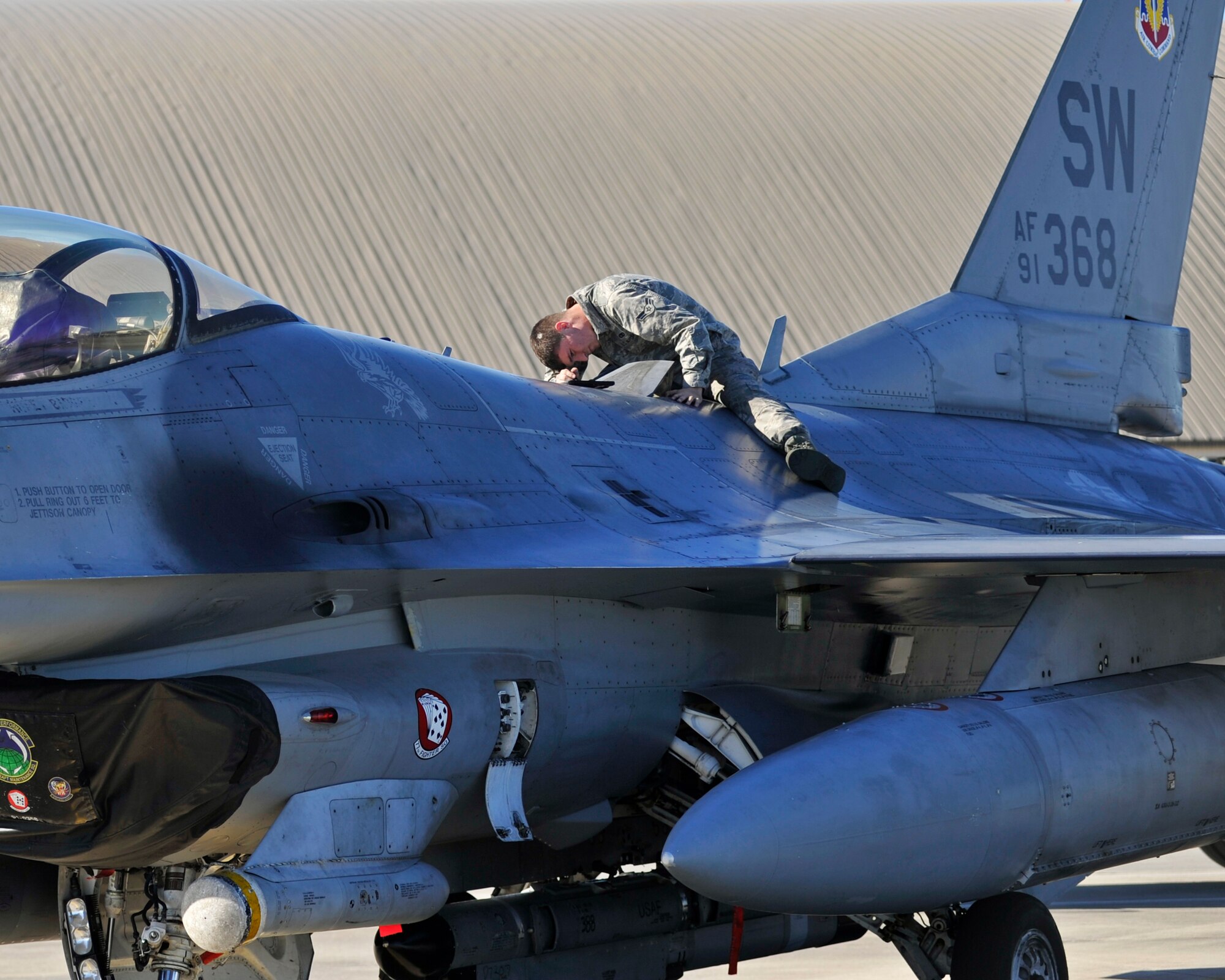 A 77th Aircraft Maintenance Unit dedicated crew chief from Shaw Air Force Base, S.C. performs maintenance on an F-16 Fighting Falcon Dec. 15 at the Tyndall AFB, Fla., flightline. The F-16 is a compact, multi-role fighter aircraft. It is highly maneuverable and has proven itself in air-to-air combat and air-to-surface attack. (U.S. Air Force photo by Senior Airman Sergio A. Gamboa/Released) 
