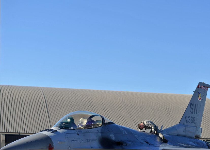A 77th Aircraft Maintenance Unit dedicated crew chief from Shaw Air Force Base, S.C. sits on an F-16 Fighting Falcon while performing maintenance Dec. 15 at the Tyndall AFB, Fla., flightline. Along with Shaw AFB, aircraft from Eglin AFB, Fla.; Barksdale AFB, La.; Tinker AFB, Okla.; Eielson AFB, Alaska; and Tyndall provided support during the Checkered Flag 16-1 exercise. (U.S. Air Force photo by Senior Airman Sergio A. Gamboa/Released)
