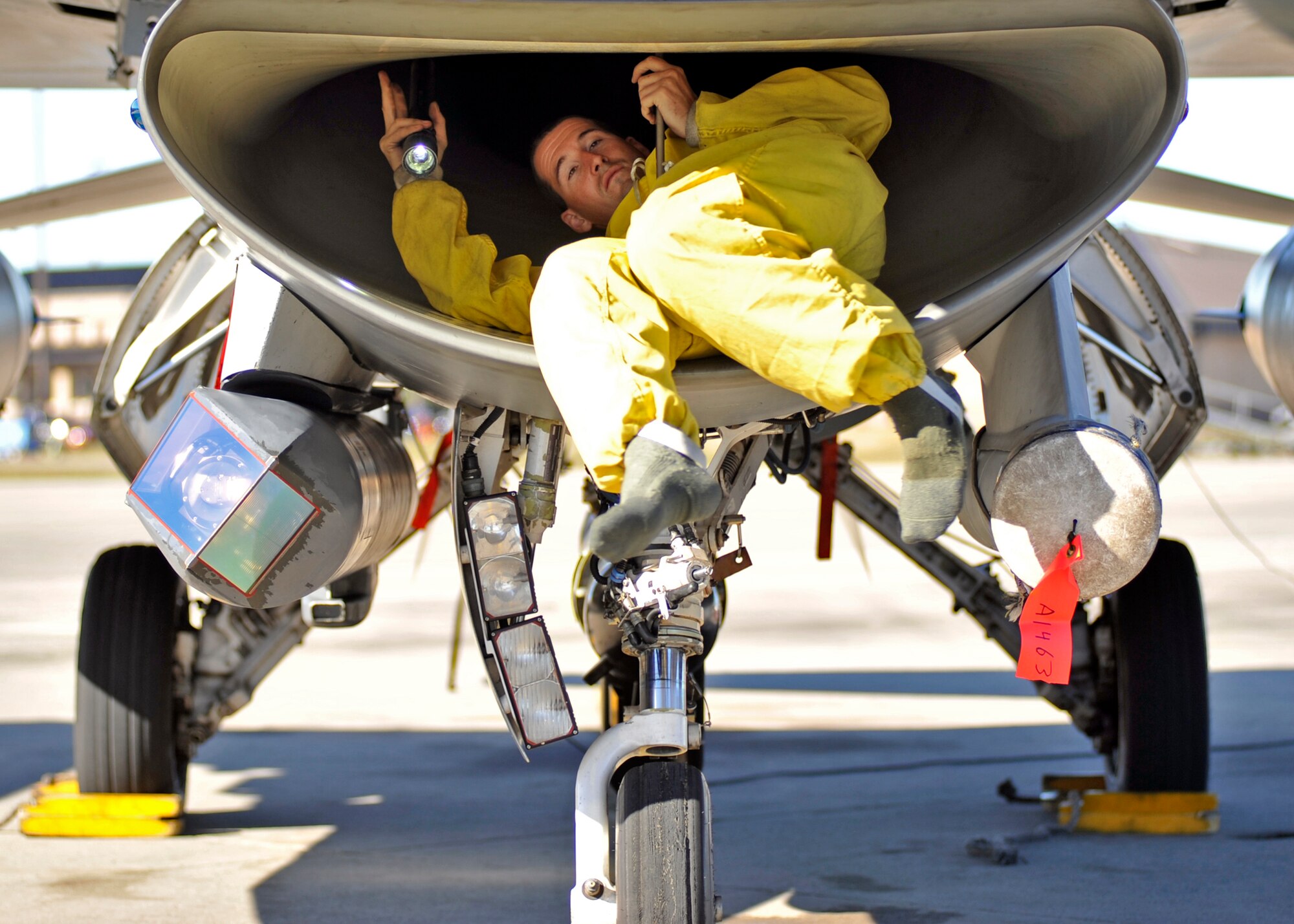A 77th Aircraft Maintenance Unit F-16 Fighting Falcon dedicated crew chief from Shaw Air Force Base, S.C. exits an F-16 Dec. 15 after performing an intake inspection. The F-16 Fighting Falcon is a compact, multi-role fighter aircraft. It is highly maneuverable and has proven itself in air-to-air combat and air-to-surface attack. (U.S. Air Force photo by Senior Airman Sergio A. Gamboa/Released)