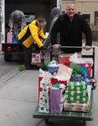 Rick Pelzl, 934th Force Support Squadron, wheels in a cart full of gifts for residents of the Minnesota Veterans Home Dec. 17. (Air Force Photo/Paul Zadach)