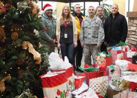 934th Airlift Wing members and Minnesota Veterans Home staff, stand with gifts donated by 934th Airlift Wing members. (Air Force Photo/Paul Zadach)