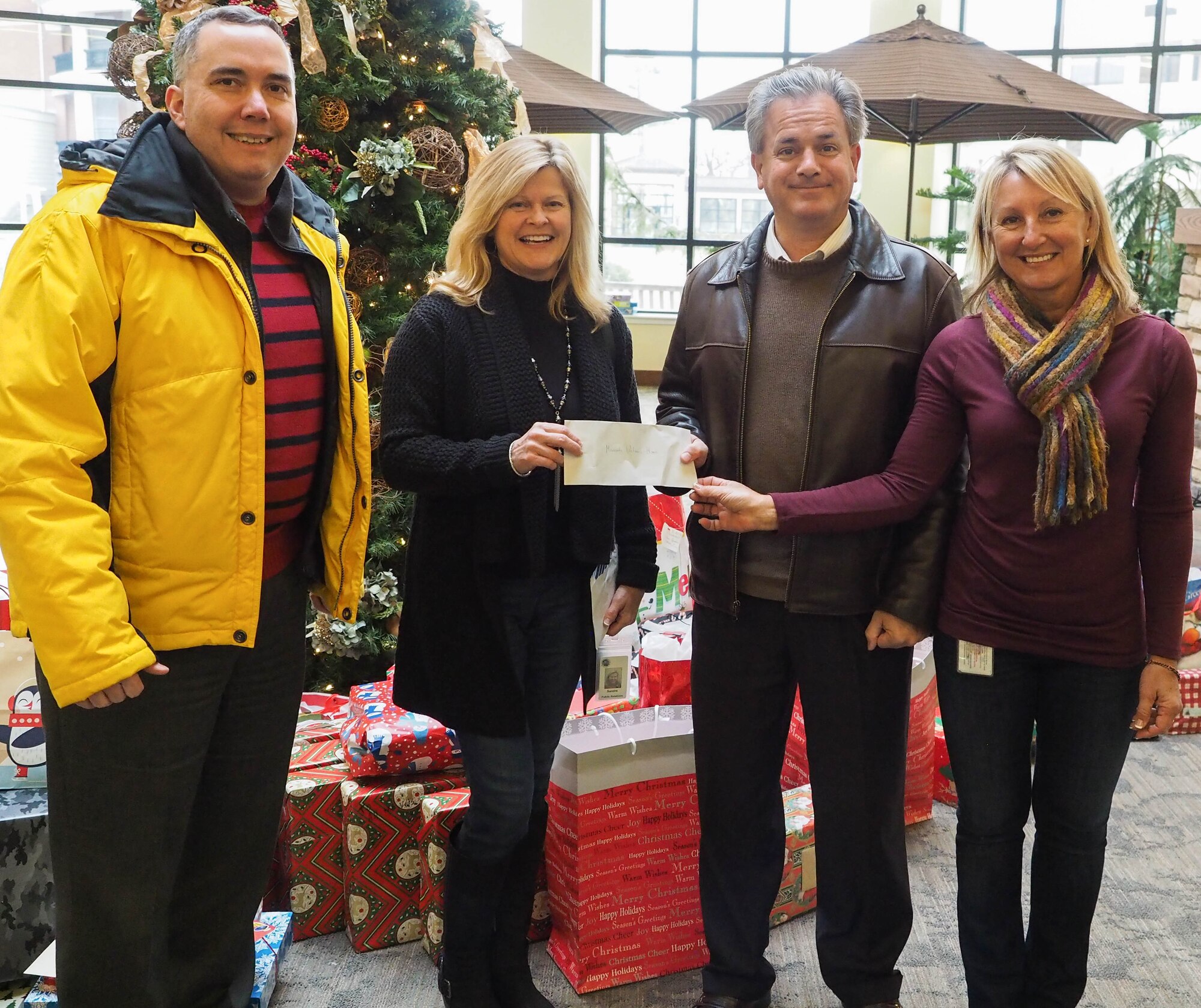 Mike Auel and Pete Mangone, 934th Financial Management, deliver a check for $7,000 to Sandy Larson of the Minnesota Veterans Home. (Air Force Photo/Paul Zadach)


