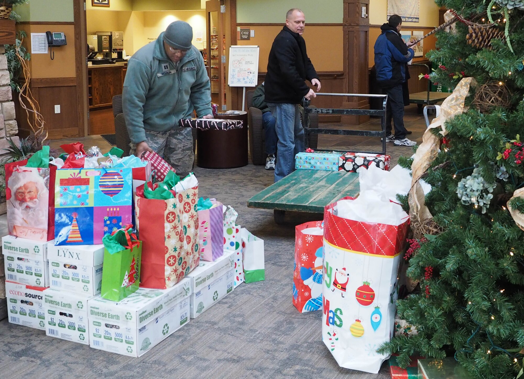 Capt. William-Joseph Mojica, 934th Airlift Wing Public Affairs Officer, delivers gifts for residents of the Minnesota Veterans Home Dec. 17. (Air Force Photo/Paul Zadach)