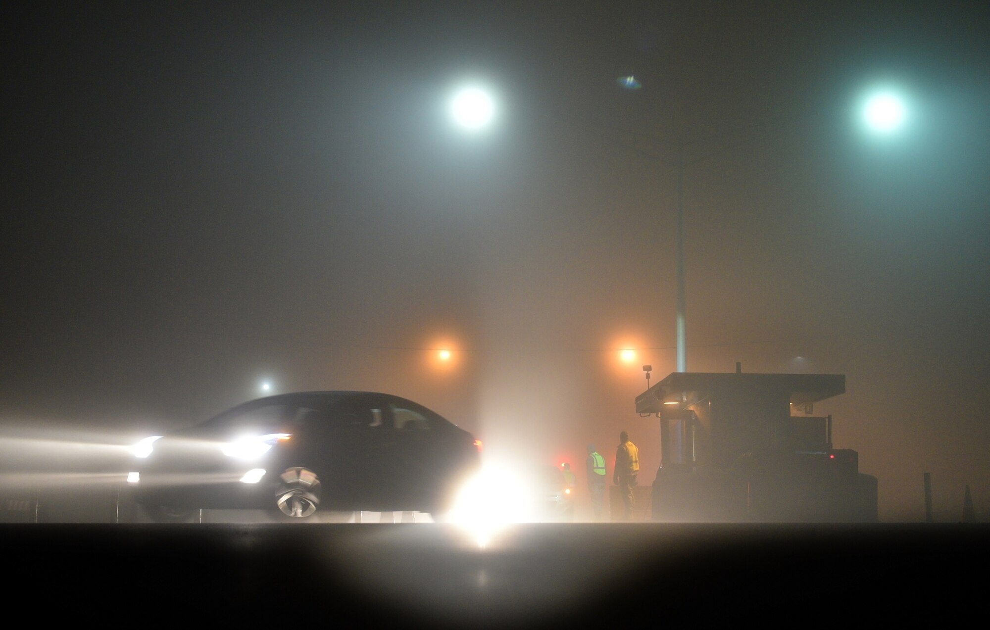 WRIGHT-PATTERSON AIR FORCE BASE, Ohio – Airmen from the 445th Security Forces Squadron perform ID checks during dense fog conditions here in the early hours as wing members come through Gate 26A to head into work for their Dec. 6, 2015 unit training assembly. (U.S. Air Force photo/Tech. Sgt. Frank Oliver)