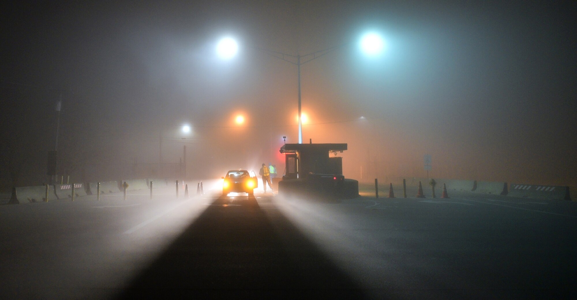 WRIGHT-PATTERSON AIR FORCE BASE, Ohio – Airmen from the 445th Security Forces Squadron perform ID checks during dense fog conditions here in the early hours as wing members come through Gate 26A to head into work for their Dec. 6, 2015 unit training assembly. (U.S. Air Force photo/Tech. Sgt. Frank Oliver)