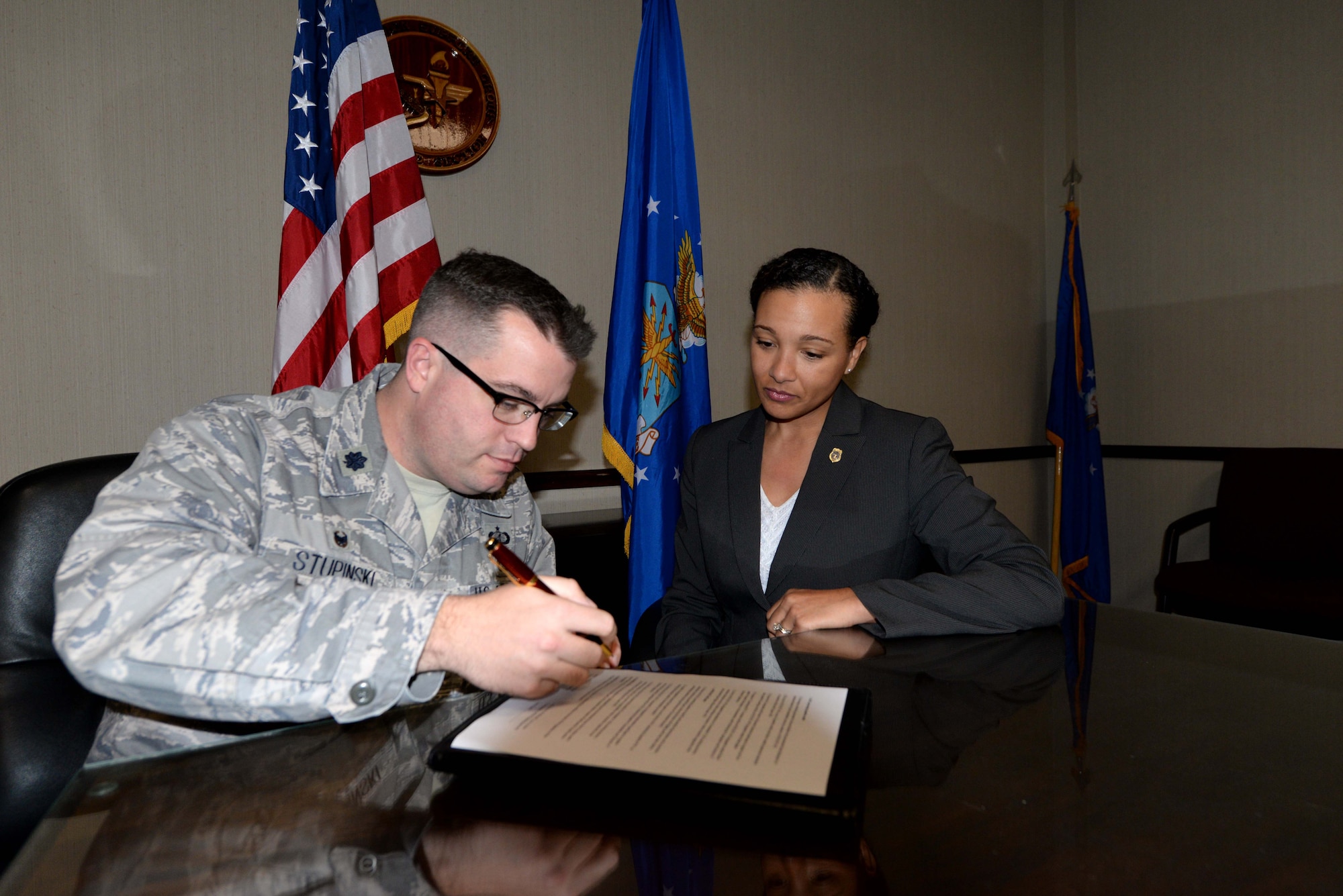 Lt. Col. Daniel Stupinski, 42d Contracting Squadron commander, left, and Special Agent Helen Stewart, Air Force Office of Special Investigations Detachment 405, sign a memorandum of agreement Dec. 8, 2015 at Maxwell Air Force Base, Alabama. The Memorandum of Agreement between the 42d CONS and the AFOSI Detachment 405 reinforces the relationship between the two parties to mitigate and prevent procurement fraud, misconduct, fraudulent activity. (U.S. Air Force photo by Airman 1st Class Alexa Culbert)