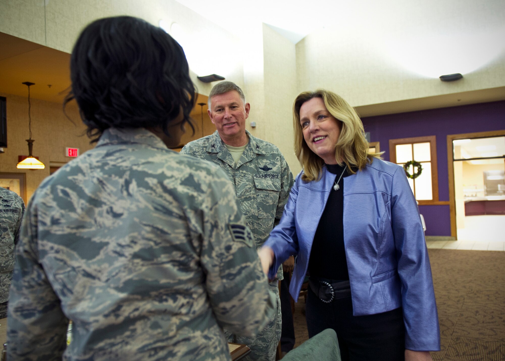 Secretary of the Air Force Deborah Lee James and Col. Doug Schwartz, 434th Air Refueling Wing commander, greet Senior Airman Courtney Dotson-Nessett, 434th Maintenance Squadron KC-135R Stratotanker hydraulic technician, at the start of an Airmen luncheon at Grissom Air Reserve Base, Ind., Dec. 16, 2015. James dined with more than 25 Airmen and key leaders to conclude her two-day visit of the base. (U.S. Air Force photo/Senior Airman Katrina Heikkinen)