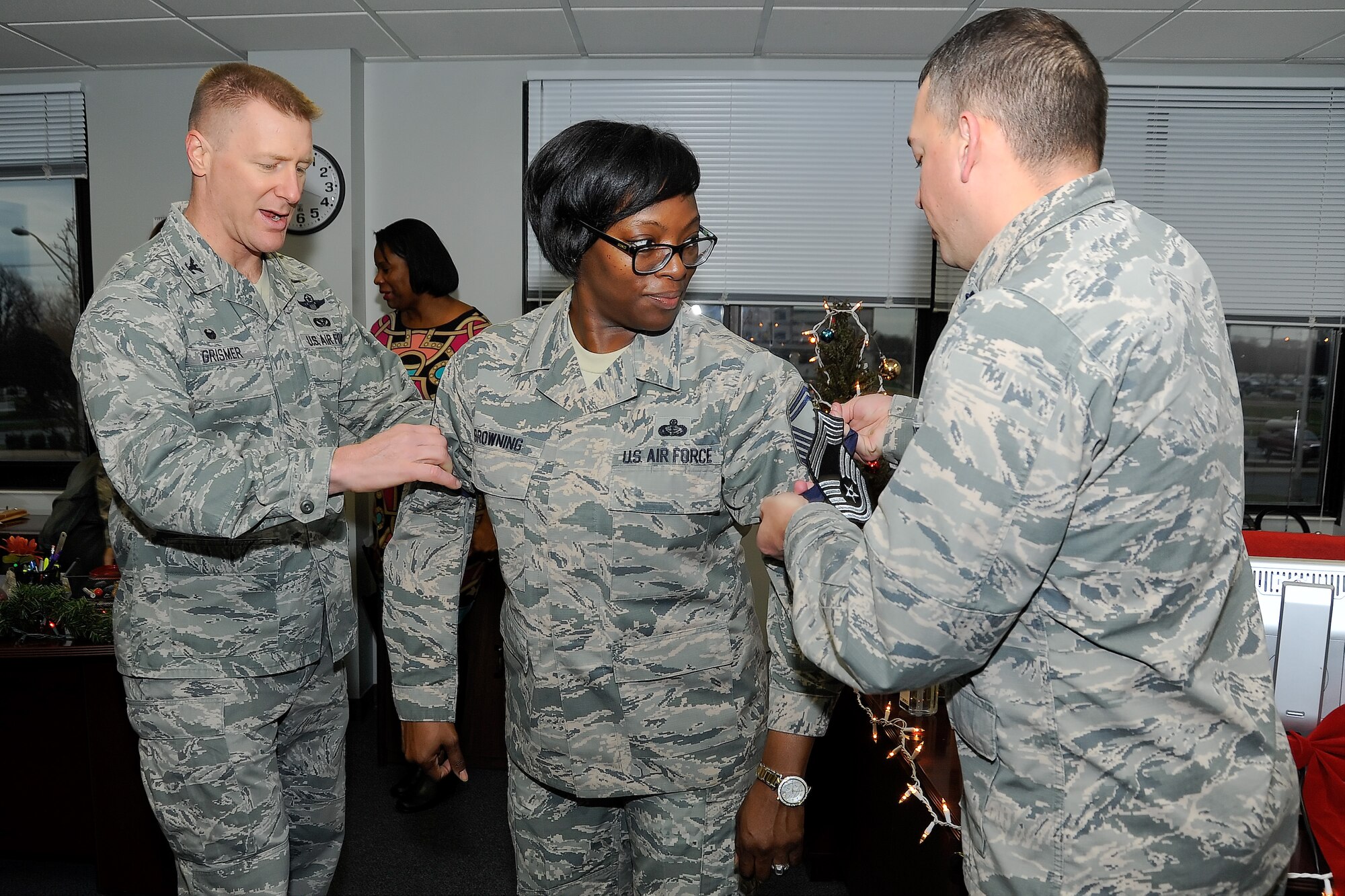 Col. Michael Grismer, 436th Airlift Wing commander, left, and Lt. Col. Donald Tasker, 436th Force Support Squadron commander, right, congratulate Senior Master Sgt. Michelle Browning, 436th FSS superintendent, of her selection for promotion to the rank of chief master sergeant Dec. 17, 2015, at Dover Air Force Base, Del. Team Dover had four senior master sergeants selected for promotion. (U.S. Air Force photo/Greg L. Davis)