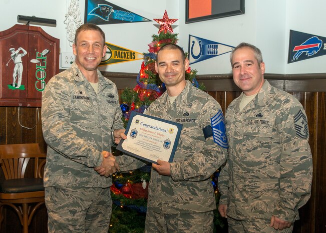 Col. John Lamontagne, 437 Airlift Wing commander and Chief Master Sgt. Kristopher Berg, 437th AW command chief, congratulate Senior Master Sgt. Bryan Whitley, 437 Aerial Port Squadron, on his selection to chief master sergeant Dec. 17, 2015 at Rookies Sports Bar in the Joint Base Charleston Club. (U.S. Air Force photo/ Staff Sgt. William A. O’Brien)