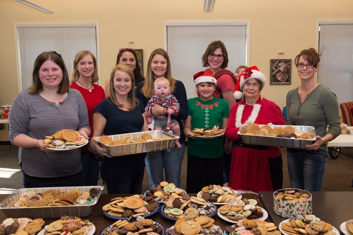 Members of the Team Charleston Spouses Club hold up platters of cookies Dec. 16, 2015, during this year’s “Operation Cookie Drop” at Joint Base Charleston, S.C. More than 5,000 freshly baked cookies were donated. The cookies were distributed to active duty service members who work overnight shifts throughout the air base and weapons station. (U.S. Air Force photo/Senior Airman Jared Trimarchi) 