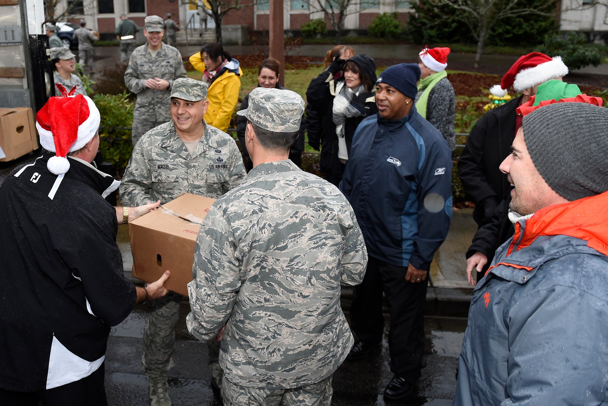 Local community leaders and 62nd Airlift Wing leadership participate in Operation Ham Grenade on Joint Base Lewis-McChord, Wash. Dec. 17, 2015. 100 hams were delivered to the 62nd AW, to be distributed out to Airmen for the December holidays. (U.S. Air Force photo/Tech. Sgt. Tim Chacon) 