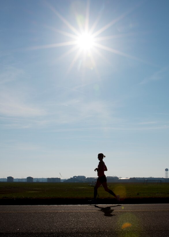 A participant in the 5th annual “Langley Race Around the Base” runs down Perimeter Road at Langley Air Force Base, Va., Dec. 12, 2015. The race course was a 10-mile loop around Langley. (U.S. Air Force photo by Staff Sgt. J.D. Strong II)