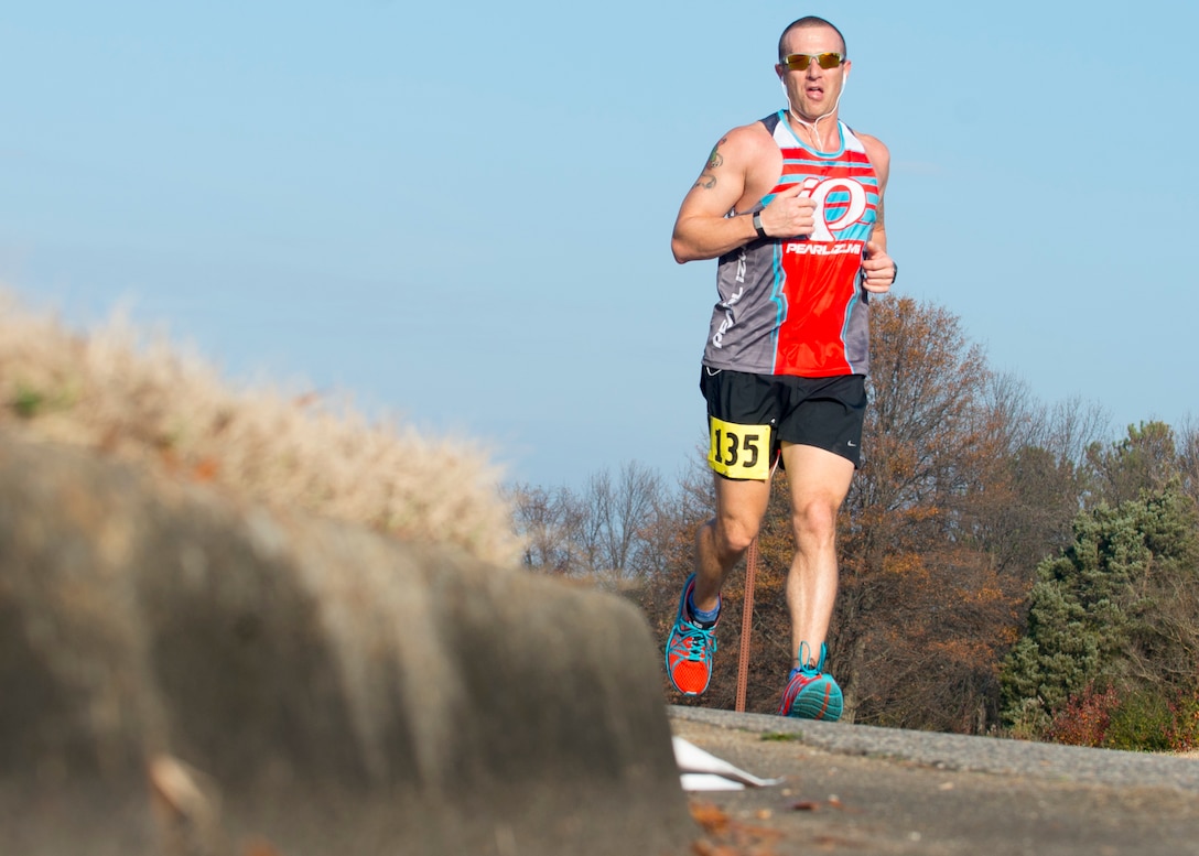 U.S. Air Force Master Sgt. Joshua Deuermyer, the manager of special activities assigned to Headquarters Air Combat Command Manpower and Organization, sprints through the halfway point during the 5th annual “Langley Race Around the Base” at Langley Air Force Base, Va., Dec. 12, 2015. In addition to the 10-mile course, there was a five kilometer course too. (U.S. Air Force photo by Staff Sgt. J.D. Strong II)