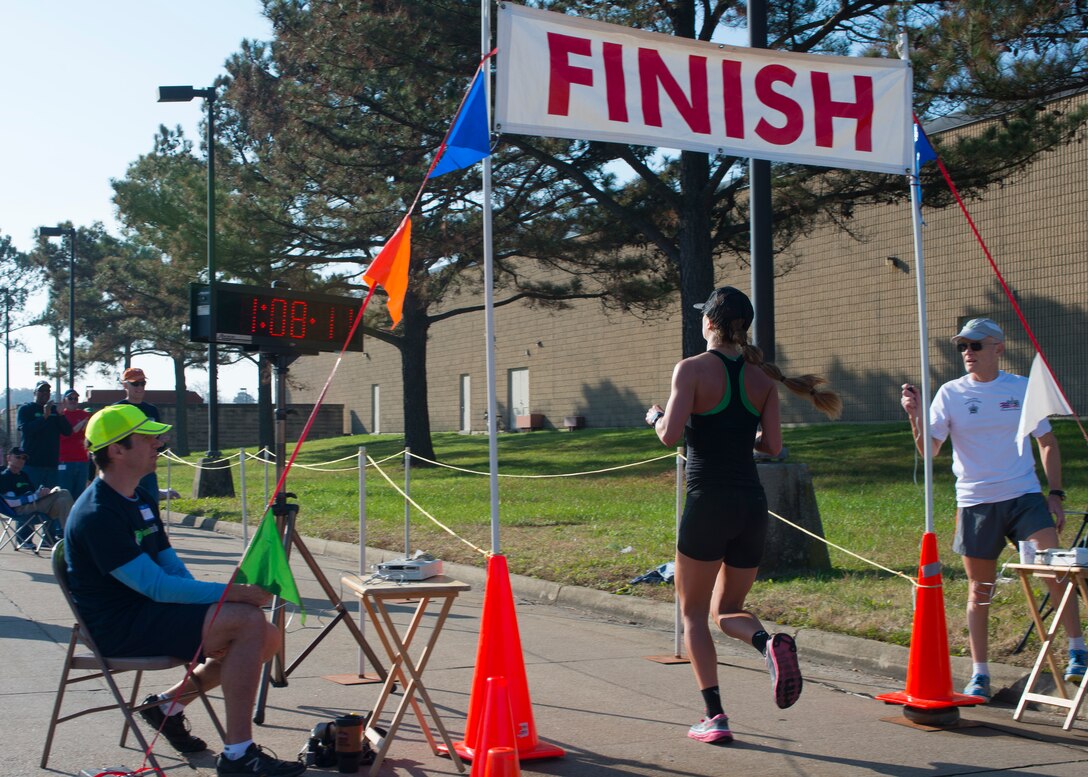 U.S. Air Force 1st Lt. Kathrine Shaw, a deputy financial services officer assigned to the 633rd Comptroller Squadron, crosses the finish line at 1:08.11 during the 5th annual “Langley Race Around the Base” at Langley Air Force Base, Va., Dec 12, 2015. Shaw was the first female to finish the 10-mile course. (U.S. Air Force photo by Staff Sgt. J.D. Strong II)