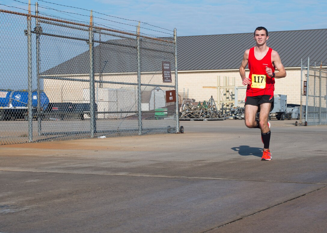 Corbin Armstrong, son of retired Chief Master Sgt. Kevin Armstrong, sprints towards the finish line during the 5th annual “Langley Race Around the Base” at Langley Air Force Base, Va., Dec. 12, 2015. Corbin was the overall winner of the 10-mile course, finishing at 1:07.03. (U.S. Air Force photo by Staff Sgt. J.D. Strong II)