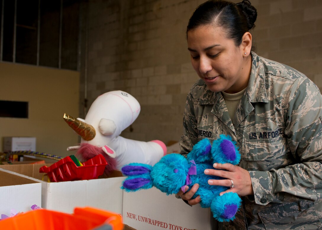 U.S. Air Force Senior Airman Soleine Izquierdo, Mission Capable (MICAP) technician assigned to the 438th Supply Chain Operations Squadron, inspects stuffed animals while volunteering at the Salvation Army at Newport News, Va., Dec. 10, 2015. Izquierdo and the rest of the 438th SCOS F-16 Fighting Falcon MICAP section’s efforts led to 4,000 children receiving toys for the holidays. (U.S. Air Force photo by Staff Sgt. J.D. Strong II)