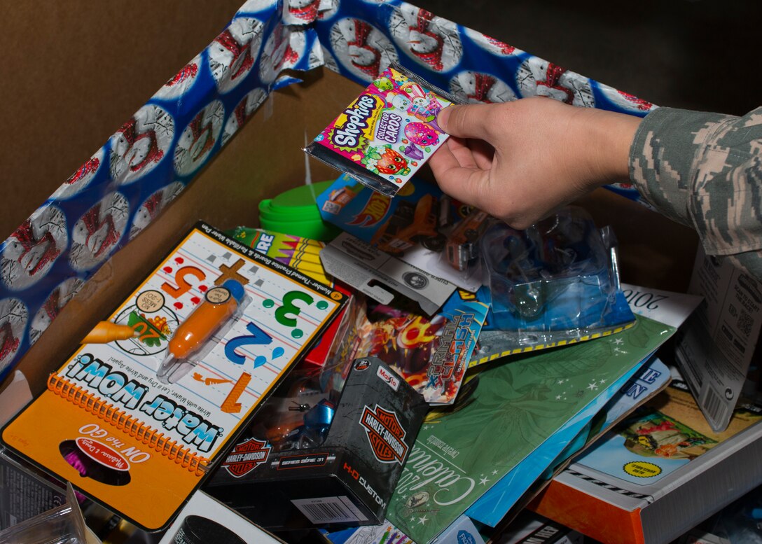 U.S. Air Force Senior Airman John Stone, Mission Capable (MICAP) technician assigned to the438th Supply Chain Operations Squadron (SCOS), separates toys while volunteering at the Salvation Army at Newport News, Va., Dec. 10, 2015. The 438th SCOS F-16 Fighting Falcon MICAP section will also be volunteering at local soup kitchens and will be designated drivers for U.S. Soldiers and Airmen Against Drunk Driving. (U.S. Air Force photo by Staff Sgt. J.D. Strong II)
