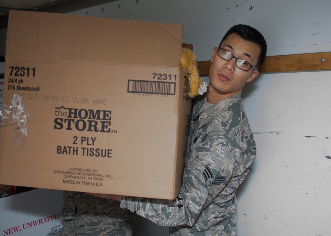U.S. Air Force Senior Airman James Choe, Mission Capable technician assigned to the438thSupply Chain Operations Squadron (SCOS), carries a box of toys while volunteering at the Salvation Army at Newport News, Va., Dec. 10, 2015. The 438th SCOS F-16 Fighting Falcon flight donated over $1,200  worth of toys to the Salvation Army. (U.S. Air Force photo by Staff Sgt. J.D. Strong II)