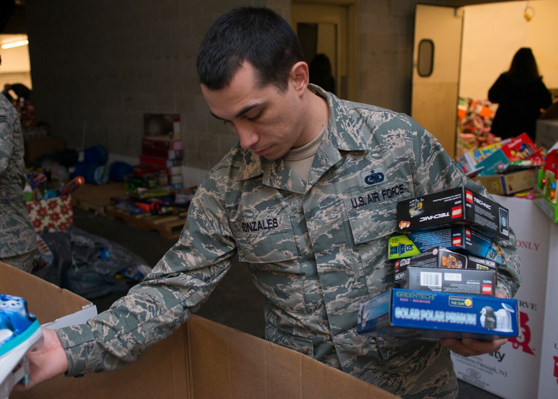 U.S. Air Force Staff Sgt. Aaron Gonzales, Mission Capable (MICAP) supervisor assigned to the 438thSupply Chain Operations Squadron (SCOS), sorts through board games and toys while volunteering at the Salvation Army at Newport News, Va., Dec. 10, 2015. The 438th SCOS F-16 Fighting Falcon MICAP section volunteered over 20 man hours with the Salvation Army. (U.S. Air Force photo by Staff Sgt. J.D. Strong II)