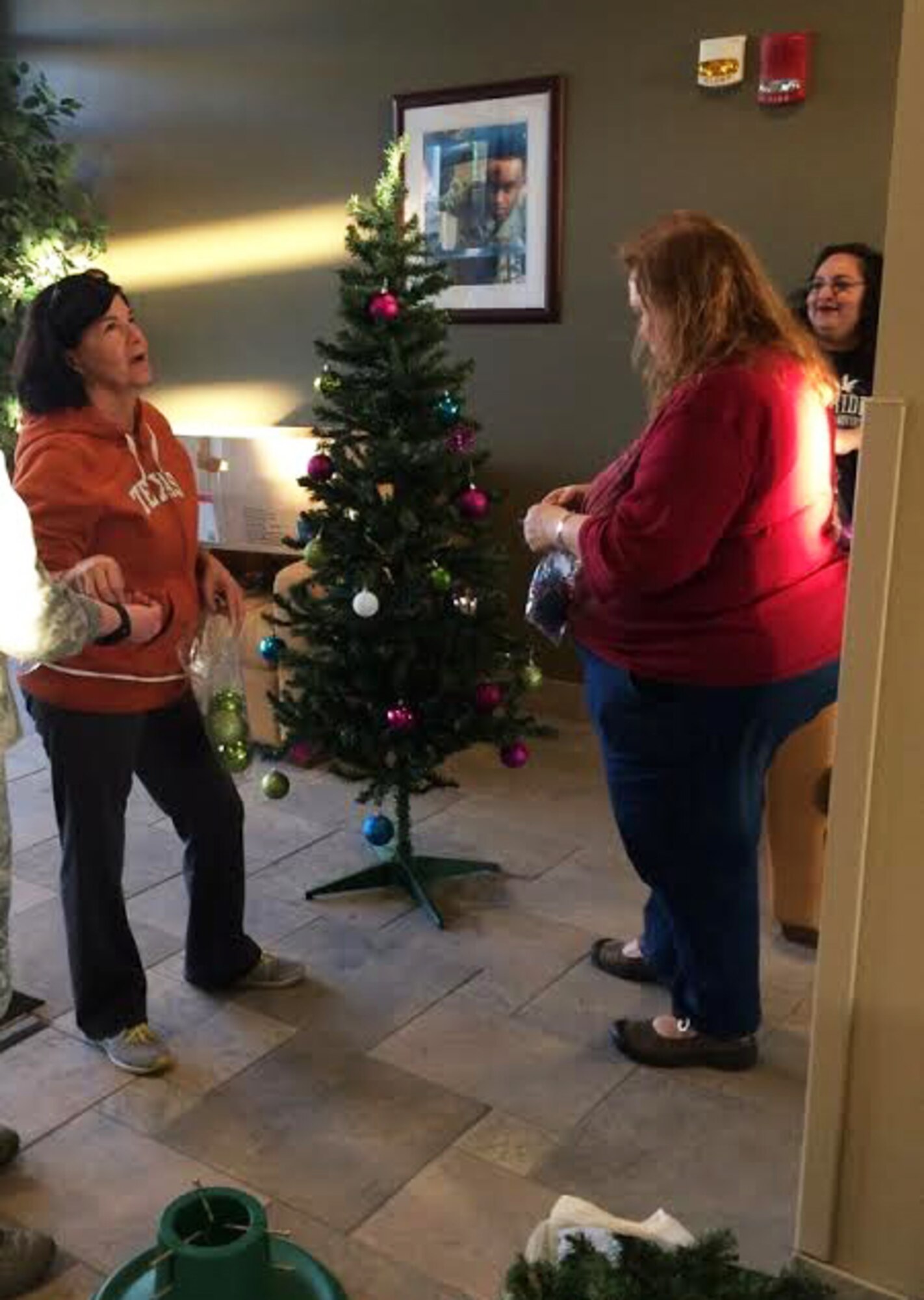 Led by the Key Spouses Group, Airmen and families decorate Christmas trees at Minot Air Force Base, N.D., Dec. 3, 2015. The volunteers decorated all the dorms with Christmas trees and garland to help spread holiday cheer. (Courtesy photo)