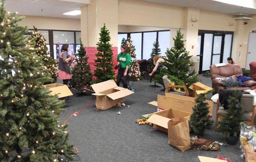 Led by the Key Spouses Group, Airmen and families decorate Christmas trees at Minot Air Force Base, N.D., Dec. 3, 2015. The volunteers decorated all the dorms with Christmas trees and garland to help spread holiday cheer. (Courtesy photo)