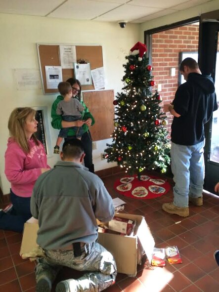 Led by the Key Spouses Group, Airmen and families decorate Christmas trees at Minot Air Force Base, N.D., Dec. 3, 2015. The volunteers decorated all the dorms with Christmas trees and garland to help spread holiday cheer. (Courtesy photo)