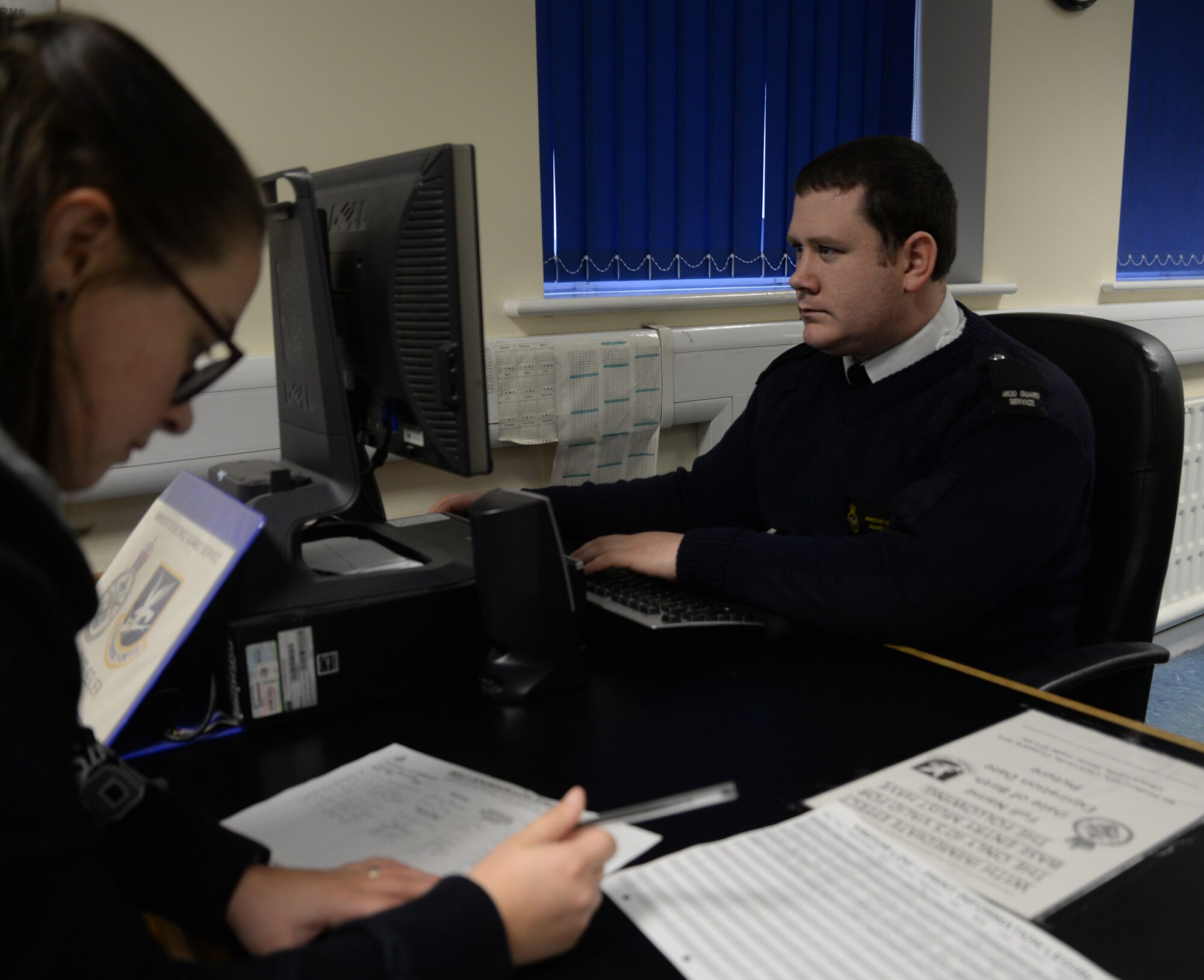 Chris Kelly, 100th Security Forces Squadron/Ministry of Defence Guard Service civilian security officer, creates a pass for a base member Dec. 15, 2015, at the visitor center on RAF Mildenhall, England. On an average day, officers inspect anywhere from 160 to 300 vehicles. Members inspect a range of cars including heavy-goods vehicles, contracting staff and visitors to the base. (U.S. Air Force photo by Senior Airman Christine Halan/Released)