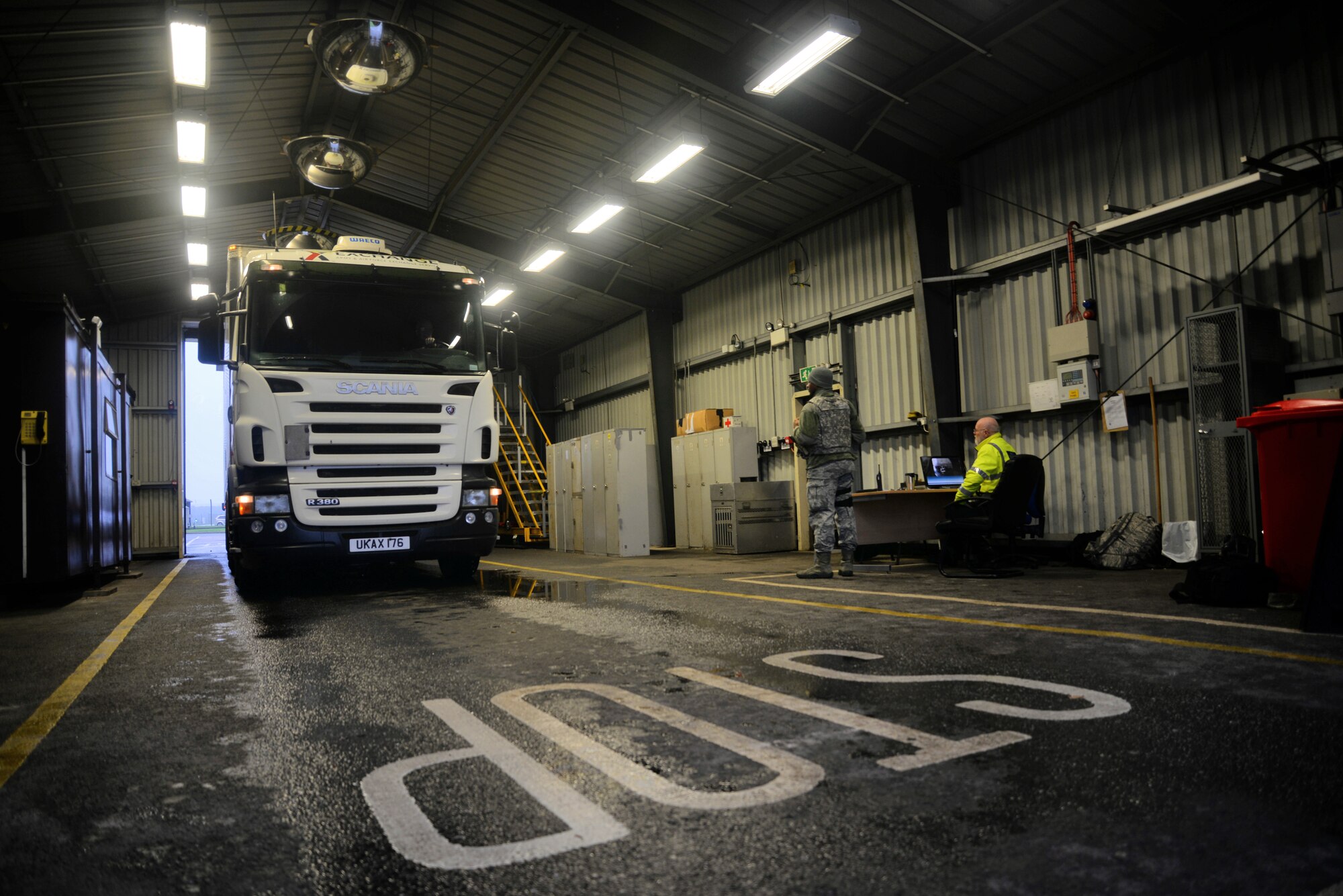 A truck enters the search barn for an inspection Dec. 15, 2015, on RAF Mildenhall, England. Airmen from the 100th Security Forces Squadron and Ministry of Defence Guard Service officers search vehicles for explosives, unauthorized people, contraband and illegal weapons. Both an armed Airman and a MGS civilian security officer are required to be in attendance during a vehicle inspection. (U.S. Air Force photo by Senior Airman Christine Halan/Released)