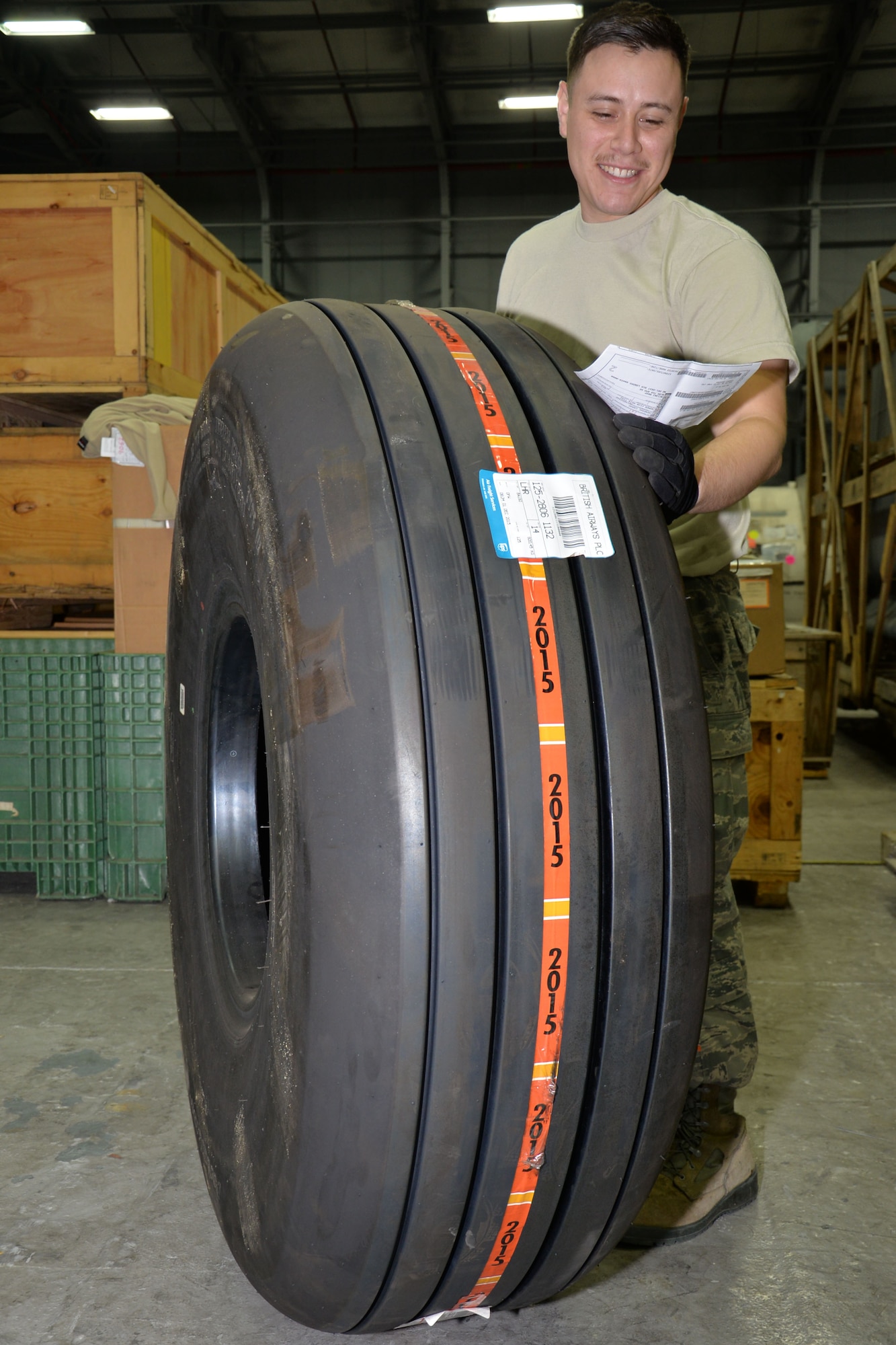 U.S. Air Force Senior Airman Marcus Anguiano, 100th Logistics Readiness Squadron Mobility Readiness Spares Packages technician, checks the paperwork and moves a tire into storage until it’s collected Dec. 10, 2015, on RAF Mildenhall, England. Anguiano received a MC-130J Commando II main aircraft tire from the U.S. The tire is required to support deployments for the 352nd Special Operations Wing. (U.S. Air Force photo by Gina Randall/Released)