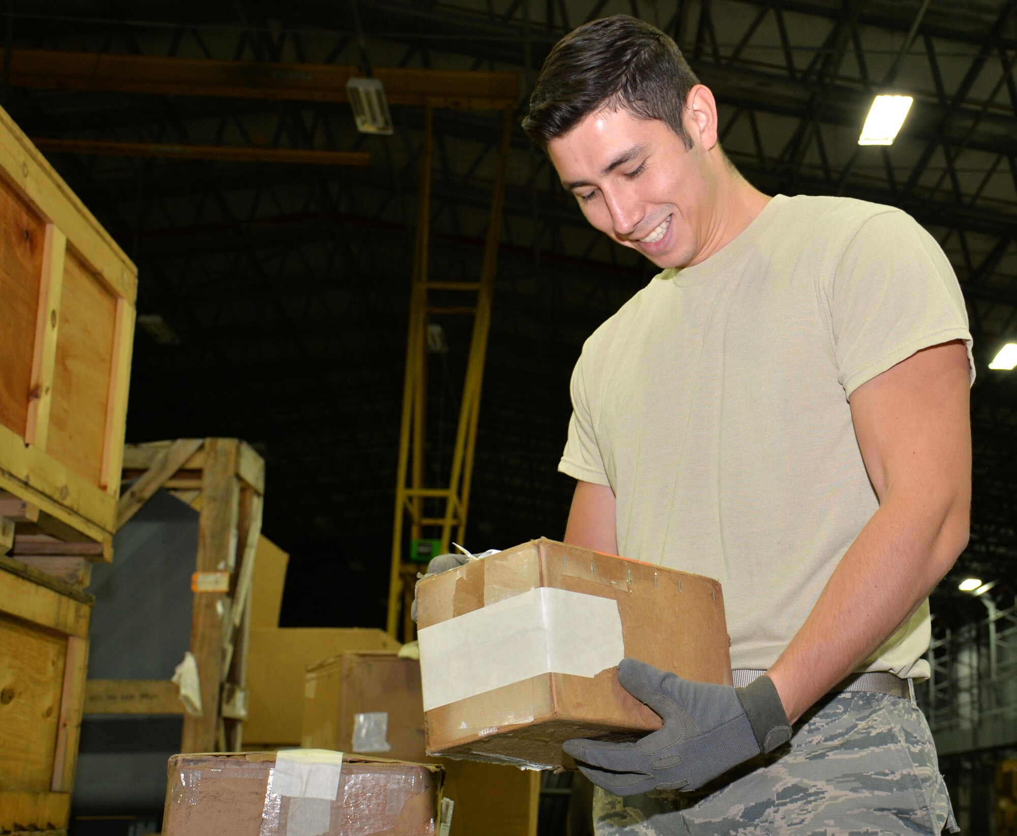 U.S. Air Force Senior Airman Juan Gavidia, 100th Logistics Readiness Squadron Mobility Readiness Spares Packages technician, checks the paperwork of a package Dec. 10, 2015, on RAF Mildenhall, England. Gavidia validates physical property with the incoming paperwork to ensure the correct assets are being received. (U.S. Air Force photo by Gina Randall/Released)